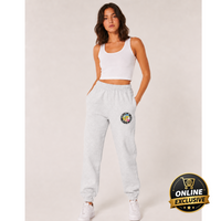 Woman wearing a white tank top and light gray sweatpants with a logo on a plain background, featuring an 'Online Exclusive' badge.